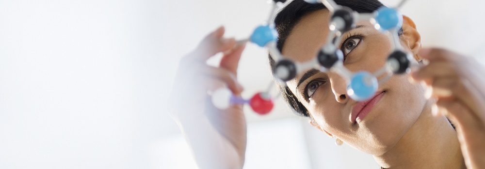 Indian scientist examining molecular model in lab; Shutterstock ID 259979534